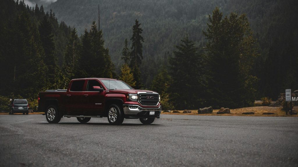 red gmc sierra in mountains